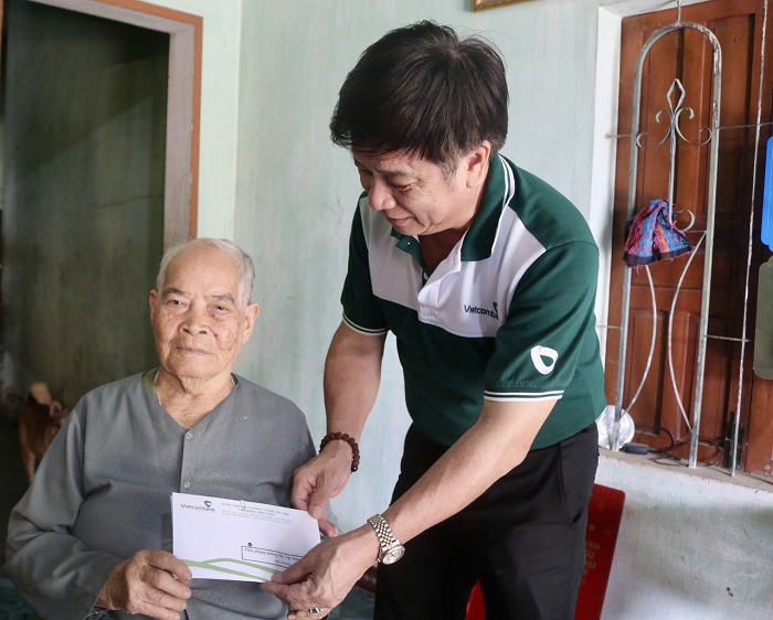 Ông Nguyễn Tấn Chúc - Phó Chủ tịch thường trực Công đoàn Vietcombank Bình Định tặng quà Mẹ Việt Nam anh hùng Võ Thị Sang