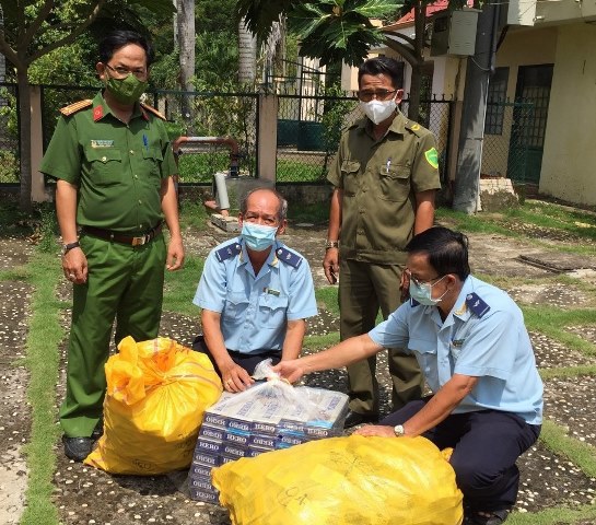 Lực lượng làm nhiệm vụ lập biên bản tạm giữ số thuốc lá điếu ngoại nhập lậu. Ảnh" T. Đạt
