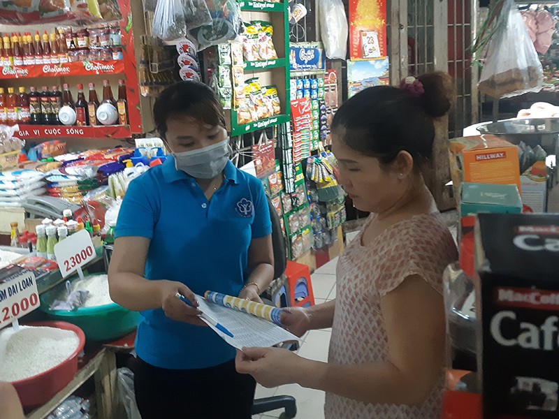 Nhân viên tư vấn các quyền lợi khi tham gia bảo hiểm xã hội tự nguyện ở chợ Đa Kao, Quận 1.