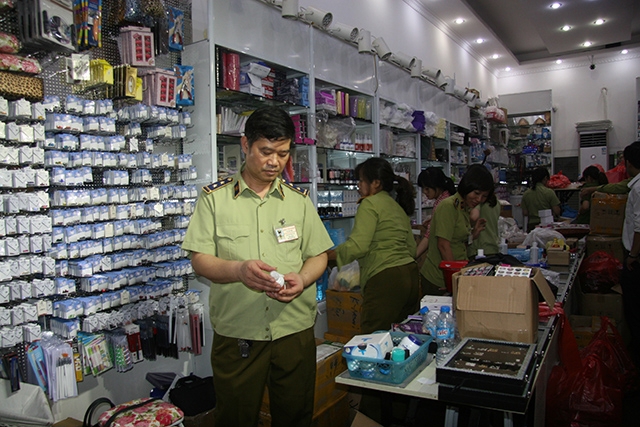 Lực lượng chức năng đang kiểm tra, thu giữ thực phẩm chức năng không rõ nguồn gốc. Ảnh: Thu Hà