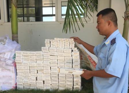 Cán bộ Hải quan An Giang kiểm kê lô hàng thuốc lá nhập lậu. Nguồn: PV.
