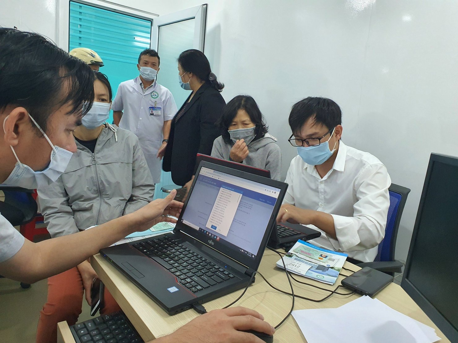 Cán bộ BHXH hỗ trợ người dân cài đặt, đăng ký ứng dụng VssID.